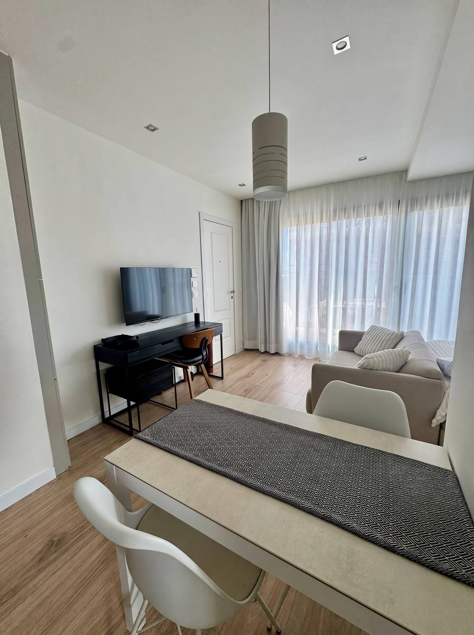 Living area with a dining table and workspace